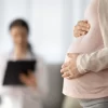 Close up of woman expecting baby having appointment with doctor
