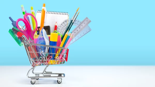 school supplies in a shopping cart