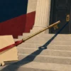 An Alabama-shaped brass key wrapped in a crimson ribbon points toward a closed courthouse door, casting a long shadow across the steps.